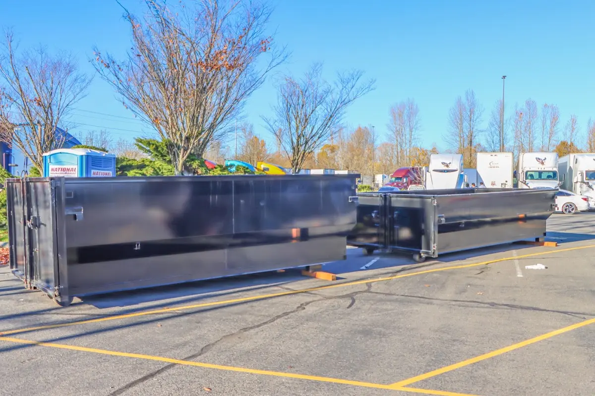 Professional dumpster rental service with roll-off container on residential driveway in Ellington